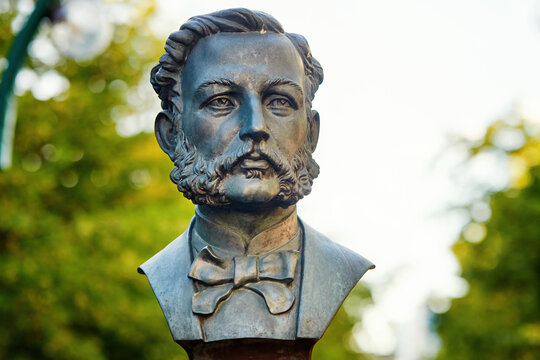 Minsk, Belarus. Jun 21, 2024. Closeup view of the bronze bust of Henry Dunant in Minsk, Belarus, set against lush greenery, paying tribute to a pioneering figure in global humanitarian efforts