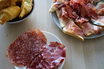 home family table served with pastries, pastrami, toasts, waiting for guests, cozy, generous, hospitality, holiday 