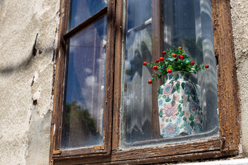 Old wooden window with flowers