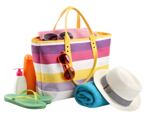 Beach bag filled with summer essentials like sunscreen, towel, hat and sunglasses on a black background