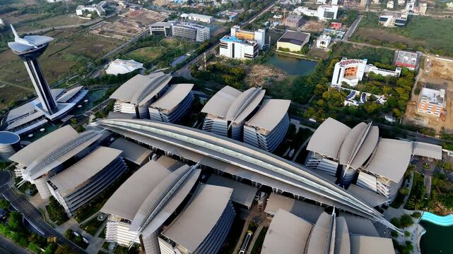 Aerial view of Chennai's IT hub in OMR. Features SIPCOT SEZ with iconic buildings, active construction, and a distant high-rise skyline. Residential high rise apartments