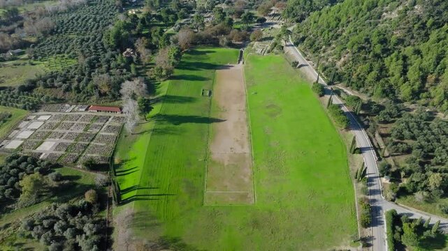 Panoramic drone shot of ancient Olympia stadium in archaeological site of Ancient Olympia on a sunny day