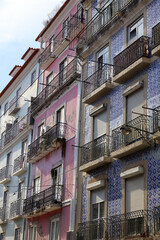 Charming Lisbon streets lined with colourful buildings, tiled facades, and steep hills create a vibrant, sunlit cityscape filled with culture, colour, and historic charm.