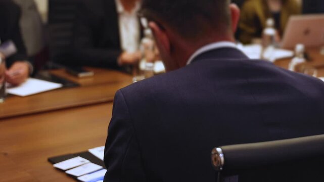 Diplomatic delegation meeting negotiation, group of men in business suits talking and discussing at conference, politicians debate and negotiate, businessmen have dialog, conversation on forum summit