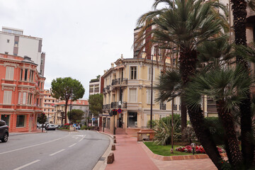 Fototapeta premium A wide view of Monaco’s elegant cityscape, nestled between the Mediterranean Sea and the hills, glowing under the southern sun with pastel buildings and coastal charm.