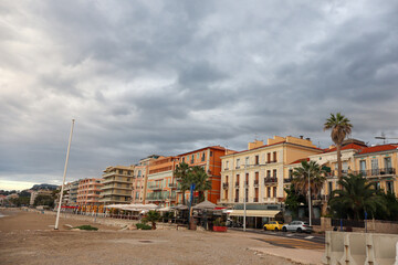 The pastel-coloured skyline of Menton glows at sunset, with charming rooftops and coastal silhouettes. A golden hour view of this French Riviera gem.