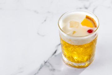 Classic cocktail whiskey sour on white marble background. Copy space