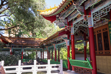  A serene Asian garden featuring a peaceful pond, lush greenery, and traditional design elements, evoking calm and reflection.