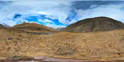 Full Spherical panorama of autumnal highland pasture on slope of the mountain at sunny afternoon in equirectangular projection