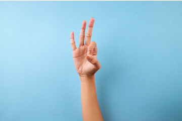 Finger Spelling Letter F In American Sign Language On Blue Background