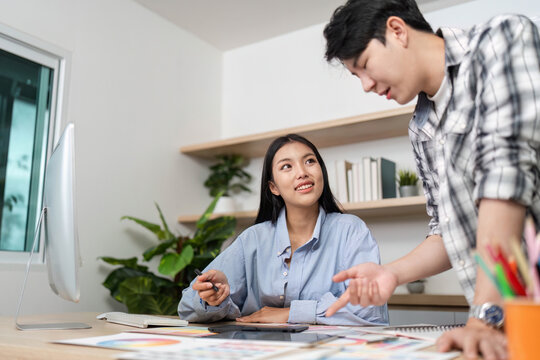 Engaging UX and UI Design Session. Designers collaborating on project ideas in a modern workspace.