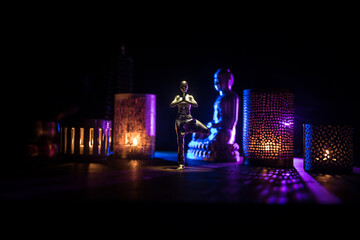 Yoga Concept with Namaste Statue and Oriental-Inspired Miniature on Table