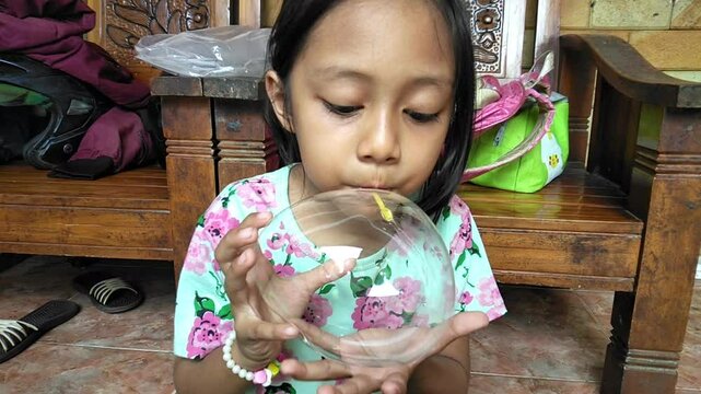 blowing up a gel balloon using a straw