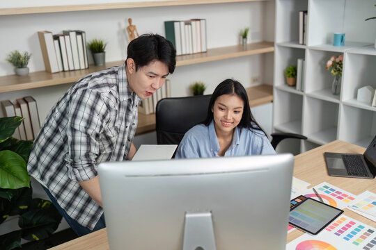 UX and UI Designers Analyzing Project on Computer. Team collaboration in a modern office.