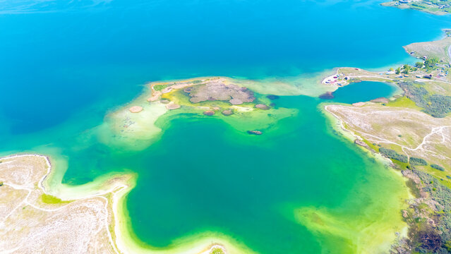 Aerial view of a tropical island with white sand beaches and volcanic features, captured by drone. Chayeri Island, Sevan, Armenia