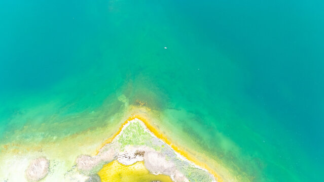 Scenic aerial drone image of a volcanic island surrounded by white sand coastline. Chayeri Island, Sevan, Armenia