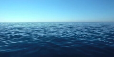 Obraz premium Calm ocean surface meets a clear, cerulean sky