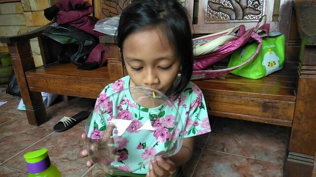 the process of inflating a gel balloon using a straw