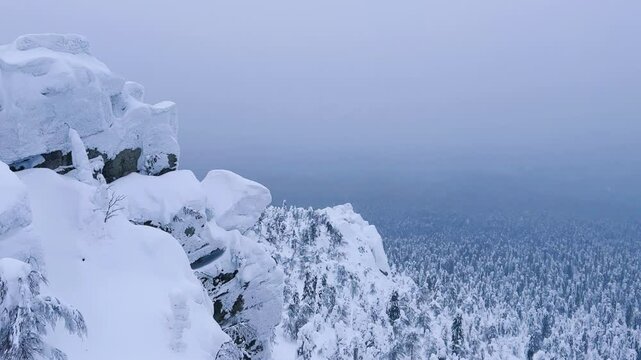 View of the white rocks and the winter forest on Mount Polyud. Lappish spruces on Mount Polyud in the Perm region in winter. In winter, there is a lot of snow and frost on the trees in the Urals. 4К	