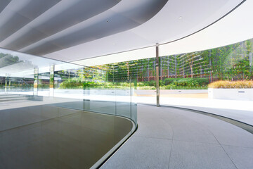 Fototapeta premium Empty corridor beside large glass wall in a modern office building. 3D Rendering