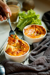 close up of mashed potatoes topping with melted mozzarella on fork warm, homemade breakfast served fresh in a cozy kitchen vertical food photography.