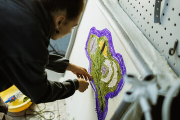 African american craftswoman checking threads on handmade rug