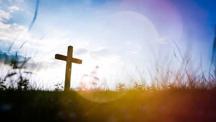 Christian cross standing on a hill at sunset, symbolizing faith and spirituality