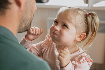 Happy Father Playing with Daughter. Three Years Baby Smiling, Laughing, Looking at Daddy. Man Showing Affection to Child. Candid Real Emotion. Beard Dad and Little Kid Girl. Authentic Family Lifestyle