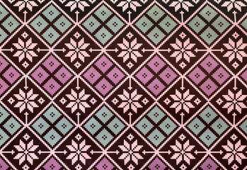 Close up of geometric floral and ornamental graphic illustration in purple, blue green color, and black color finish. Seamless background texture.