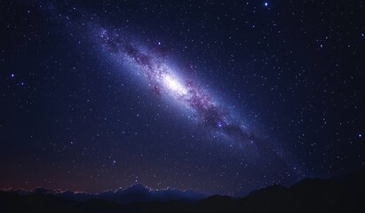 Fototapeta premium Milky Way galaxy spanning a star-studded night sky, with mountains in the foreground