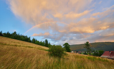 Rainbow Over Mountain Village Sunset