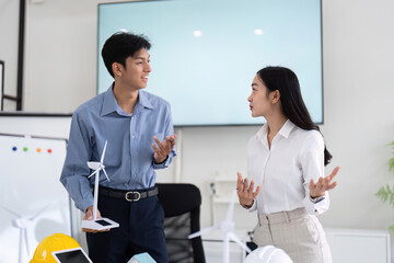 Obraz premium Sustainability and Engineering Interaction. Engineers discussing project details and future plans.