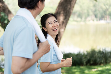 Wellness and Senior Fitness. Seniors enjoying a joyful jog by the lake, promoting health and happiness.