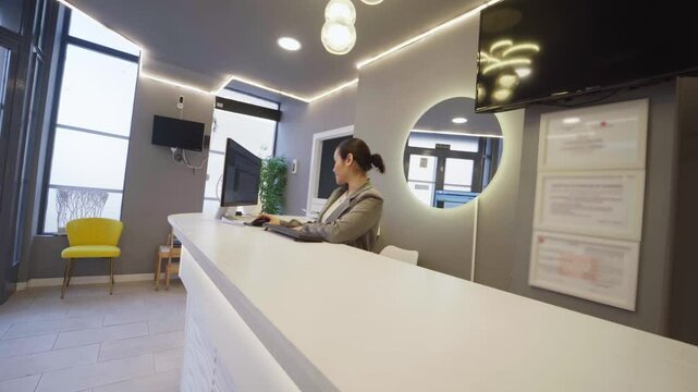 Dental clinic receptionist working on computer