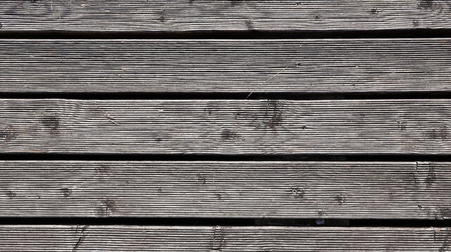 Assi di legno in cinque pezzi con una superficie a strisce del pavimento come sfondo