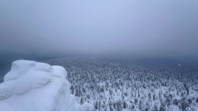View of the white rocks and the winter forest on Mount Polyud. Lappish spruces on Mount Polyud in the Perm region in winter. In winter, there is a lot of snow and frost on the trees in the Urals. 4К	