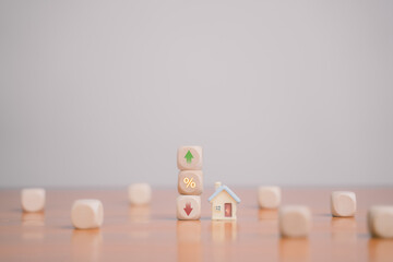The wooden block with the word interest represents increased financial concerns and investment. It...