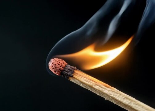 Burning Matchstick Close-Up with Flame and Smoke &ndash; Ignition Concept on Black Background in High Detail.