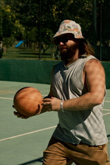 Middle-aged caucasian man playing basketball alone in the hotel of Turkey.