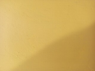 Vibrant Yellow Plaster Wall with Subtle Texture