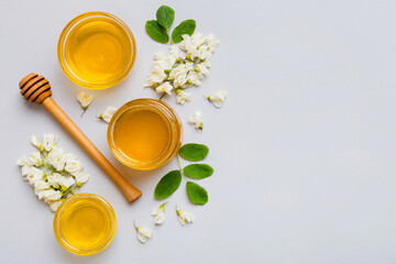 honey jar with acacia flowers and leaves. fresh honey top view flat lay