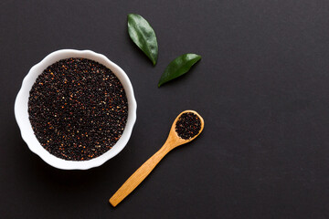 quinoa seeds in bowl and spoon on colored background. Healthy kinwa in small bowl. Healthy superfood