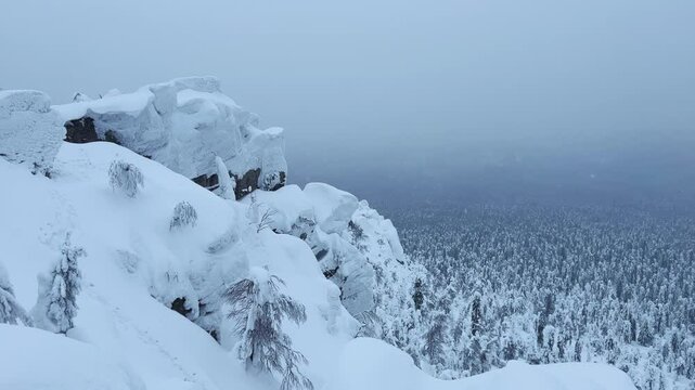 View of the white rocks and the winter forest on Mount Polyud. Lappish spruces on Mount Polyud in the Perm region in winter. In winter, there is a lot of snow and frost on the trees in the Urals. 4К	