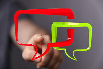 Hand interacting with 3D speech bubbles,communication, conversation, feedback concept.