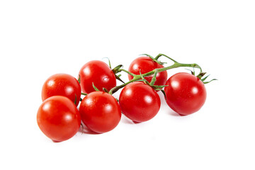 Branch of fresh ripe cherry tomatoes isolated on a white.