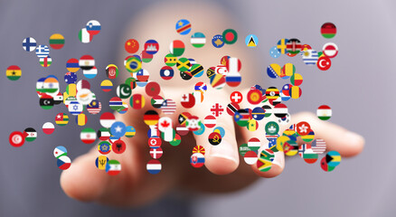 Image of hands holding many flags representing global connections and international relations.