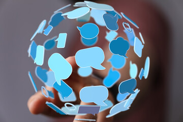 Abstract image of a person interacting with a sphere of blue speech bubbles, representing global...