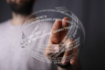 Close-up of a person interacting with a holographic display showing internet data and code.