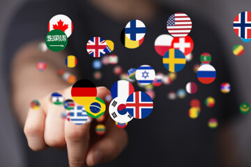 Person touching digital flags, representing global connection and communication.