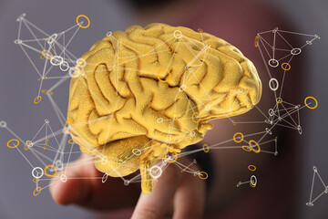 3D rendering of a golden brain with neural network connections.  Concept for AI, intelligence, and...